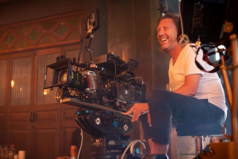 Maher Maleh sitzt an einem Filmset hinter einer Kamera